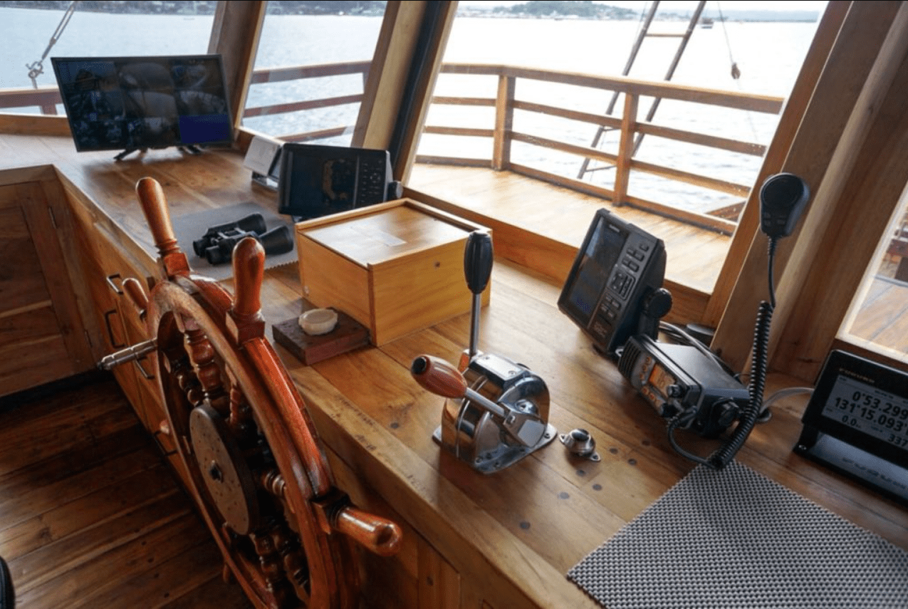 A view of the steering wheel of a boat.
