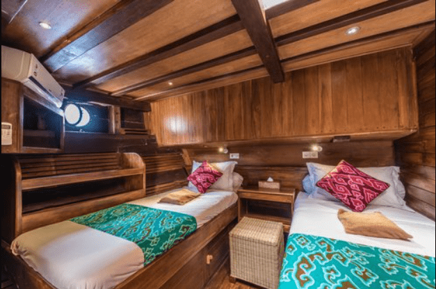 Two twin beds in a wooden boat.