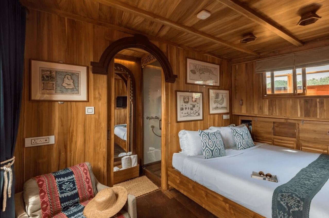 A room with wooden walls and a bed.