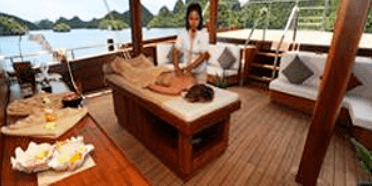 A woman is getting a massage on a boat.