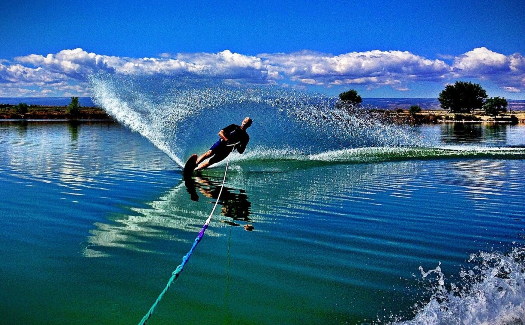 A man is water skiing on a lake.