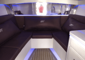 The luxurious interior of a 2020 Donzi 41 GTZ boat, featuring a comfortable couch and mesmerizing blue lights.