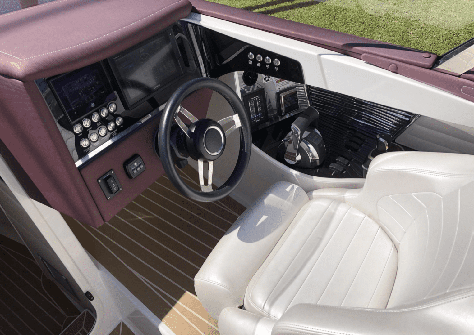 The interior of a 2020 Donzi 41 GTZ boat with a steering wheel.