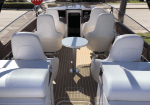 The luxurious interior of a 2020 Donzi 41 GTZ boat with comfortable white seats and a sleek steering wheel.
