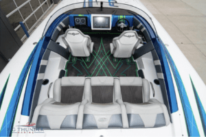 The interior of a 2018 blue and white speed boat, the Fountain 32 Thundercat, available for sale.