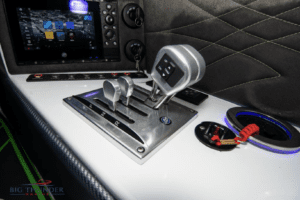 The steering wheel and controls of a 2018 Fountain 32 Thundercat boat for sale.
