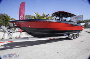 A 2021 Fountain 34 SC, a red and black boat on a trailer, is available for sale.