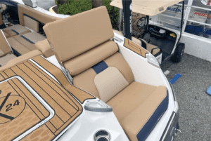 A 2023 MasterCraft X24 boat for sale, featuring a tan and brown interior.