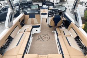 The 2023 Master Craft X24 for sale features a stunning interior with tan leather seats, offering luxurious comfort on the water.