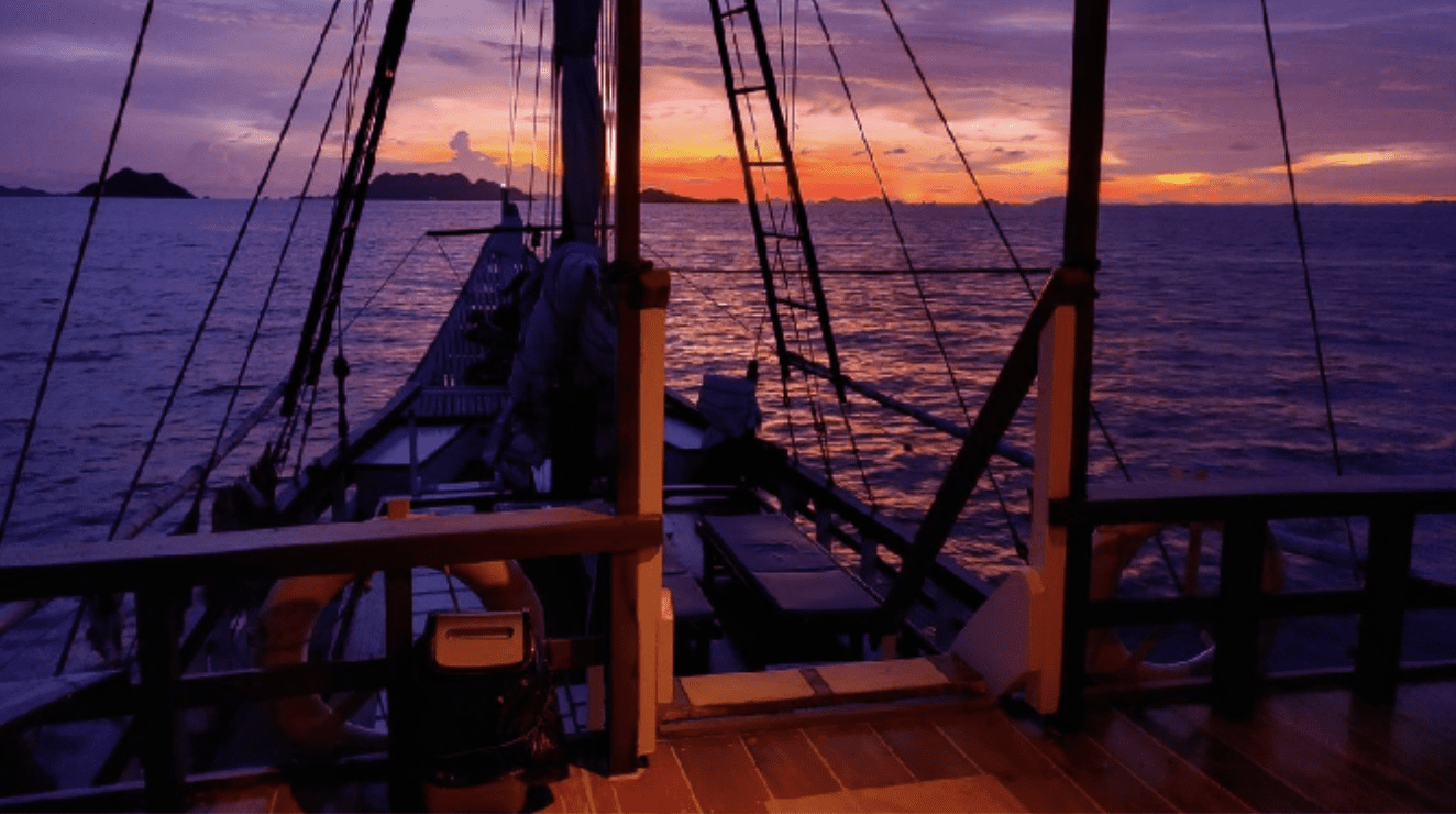 A serene view from the deck of a sailboat at sunset in 2023.