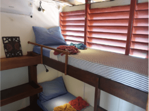A small room on a boat with a bunk bed for 2023.
