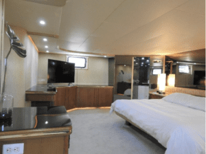 A Tarrab 112 bedroom on a yacht with a bed and tv.