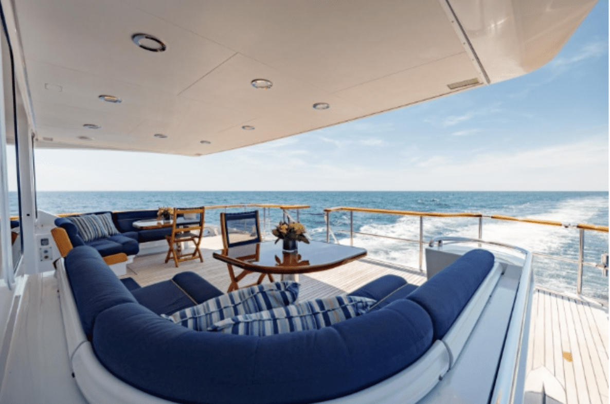 The oceanco 126 living room of a luxury yacht with blue couches.