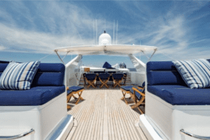 The deck of an oceanco yacht with blue cushions.
