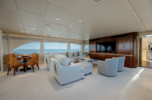A spacious living room on an Oceanco 126 yacht with panoramic ocean views.