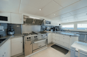 A kitchen on an oceanco 126 catamaran with stainless steel appliances.