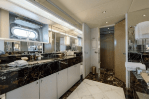 A oceanco 126 luxury yacht bathroom with marble countertops.